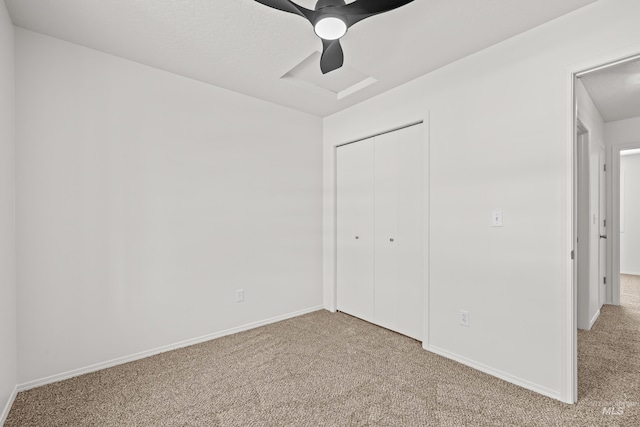 unfurnished bedroom with carpet floors, a closet, and ceiling fan