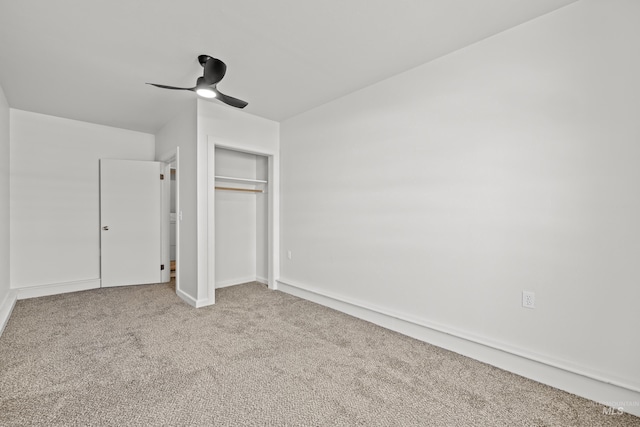 unfurnished bedroom with carpet, ceiling fan, and a closet