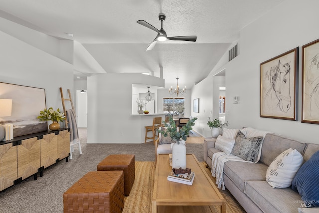 living room with ceiling fan with notable chandelier, carpet floors, vaulted ceiling, and a textured ceiling