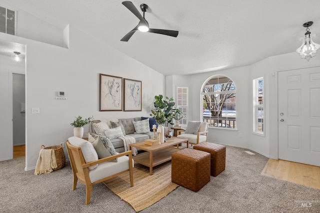 living room featuring lofted ceiling, carpet, and ceiling fan