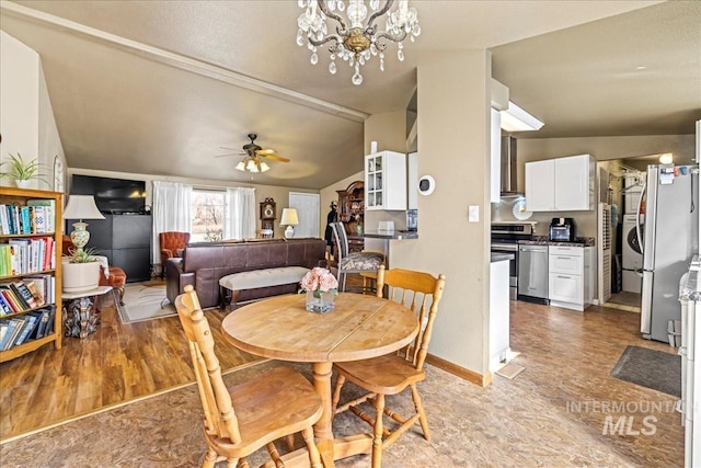 dining area with ceiling fan with notable chandelier, vaulted ceiling, and baseboards