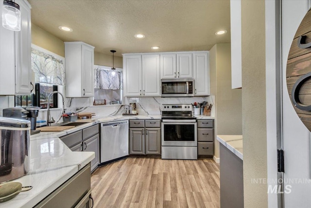 3976 Ranch Ln, Emmett, ID 83617 - kitchen featuring recessed lighting, light wood finished floors, stainless steel appliances, gray cabinets, and a sink
