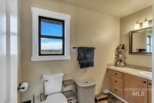 3976 Ranch Ln, Emmett, ID 83617 - bathroom featuring baseboards, vanity, and toilet