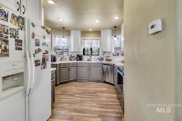 3976 Ranch Ln, Emmett, ID 83617 - kitchen with gray cabinetry, stainless steel appliances, a textured ceiling, and recessed lighting