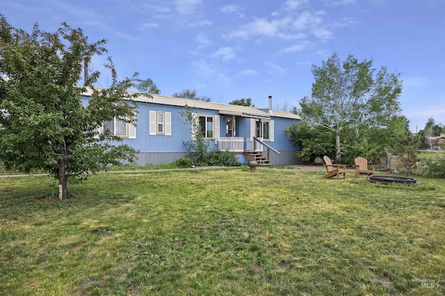 104 Poverty Ln, West Magic, ID 83352 - manufactured / mobile home featuring a front yard, an outdoor fire pit, and a metal roof