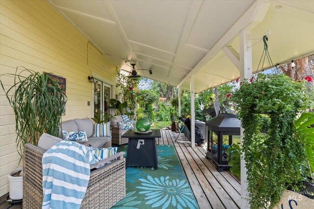 wooden terrace featuring an outdoor living space