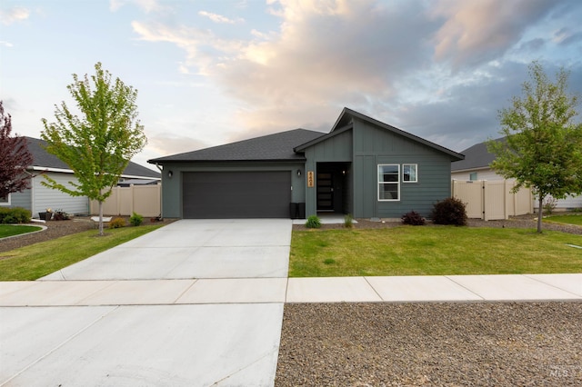 8408 E Dutchman St, Nampa, ID 83687 - view of front of property featuring board and batten siding, an attached garage, fence, and concrete driveway