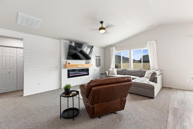 8408 E Dutchman St, Nampa, ID 83687 - living area featuring a fireplace, a ceiling fan, wood finished floors, lofted ceiling, and visible vents