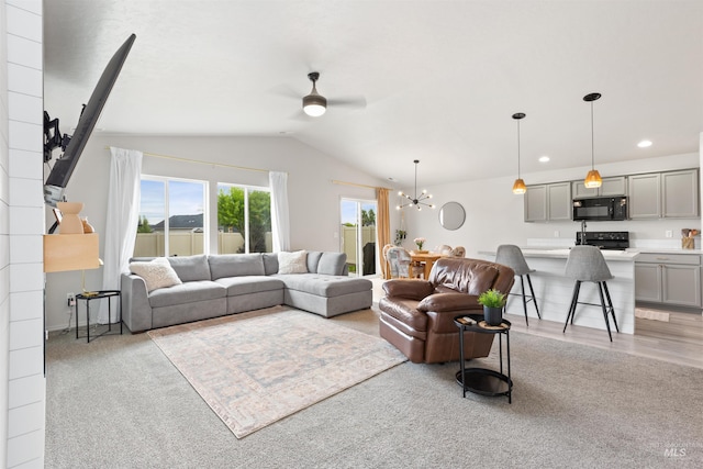 8408 E Dutchman St, Nampa, ID 83687 - living area featuring ceiling fan with notable chandelier, recessed lighting, light colored carpet, and lofted ceiling