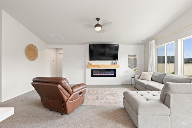 8408 E Dutchman St, Nampa, ID 83687 - carpeted living area featuring a glass covered fireplace, visible vents, a ceiling fan, and lofted ceiling