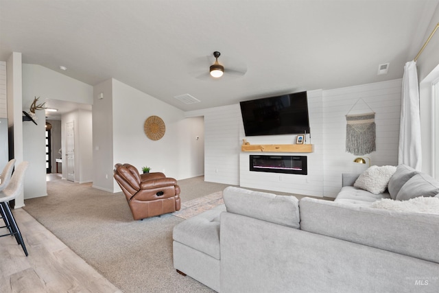 8408 E Dutchman St, Nampa, ID 83687 - living area with ceiling fan, a glass covered fireplace, wood finished floors, lofted ceiling, and visible vents