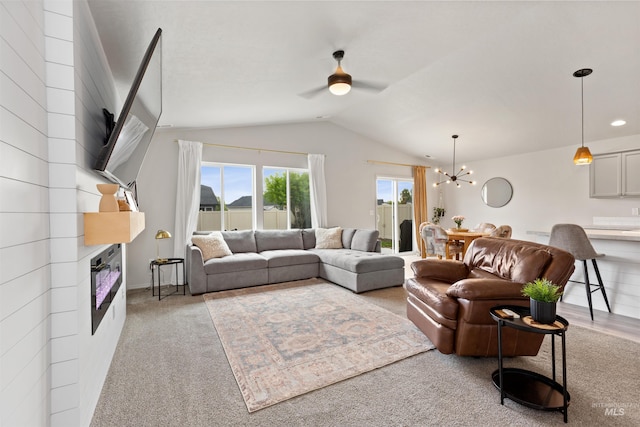 8408 E Dutchman St, Nampa, ID 83687 - living room featuring light colored carpet, ceiling fan with notable chandelier, vaulted ceiling, and a fireplace