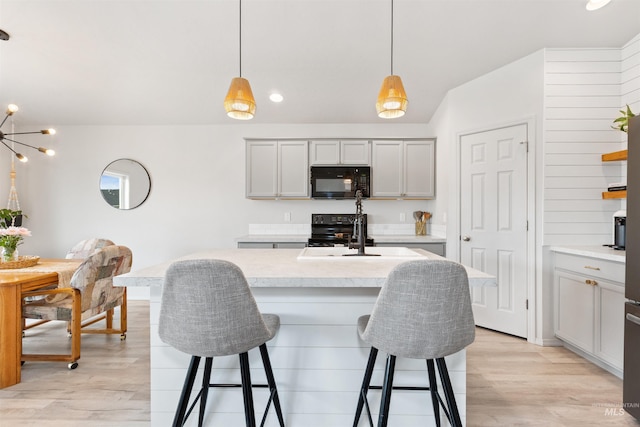 8408 E Dutchman St, Nampa, ID 83687 - kitchen featuring a sink, light countertops, black appliances, and light wood finished floors