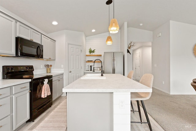 8408 E Dutchman St, Nampa, ID 83687 - kitchen with a breakfast bar area, light countertops, a sink, black appliances, and vaulted ceiling