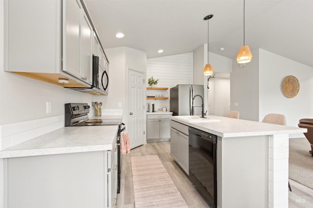 8408 E Dutchman St, Nampa, ID 83687 - kitchen with light countertops, open shelves, light wood-style flooring, and black appliances