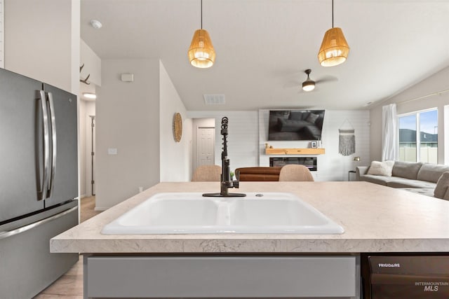8408 E Dutchman St, Nampa, ID 83687 - kitchen featuring visible vents, freestanding refrigerator, open floor plan, a sink, and dishwasher
