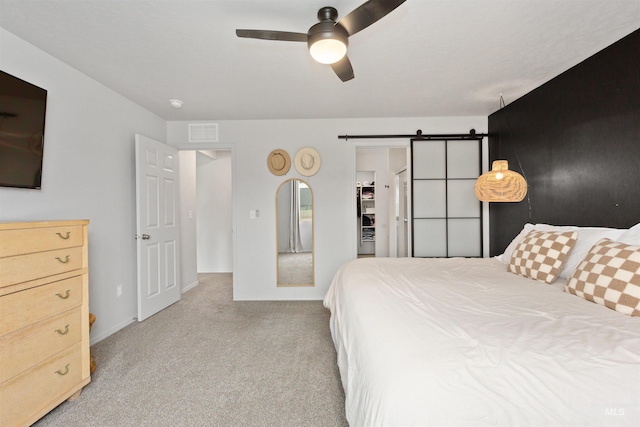 8408 E Dutchman St, Nampa, ID 83687 - bedroom featuring carpet flooring, a barn door, a walk in closet, a ceiling fan, and visible vents