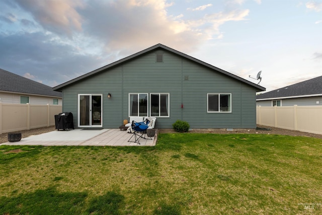 8408 E Dutchman St, Nampa, ID 83687 - back of property featuring a patio, a fenced backyard, and a lawn