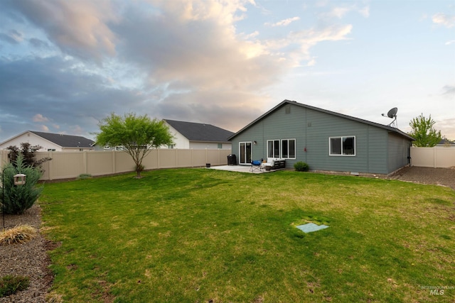 8408 E Dutchman St, Nampa, ID 83687 - rear view of house with a patio, a fenced backyard, and a lawn