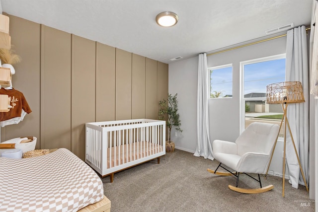 8408 E Dutchman St, Nampa, ID 83687 - carpeted bedroom featuring visible vents, a crib, and a decorative wall
