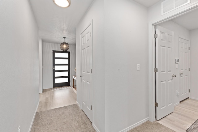 8408 E Dutchman St, Nampa, ID 83687 - foyer with light colored carpet, baseboards, visible vents, and light wood-style floors