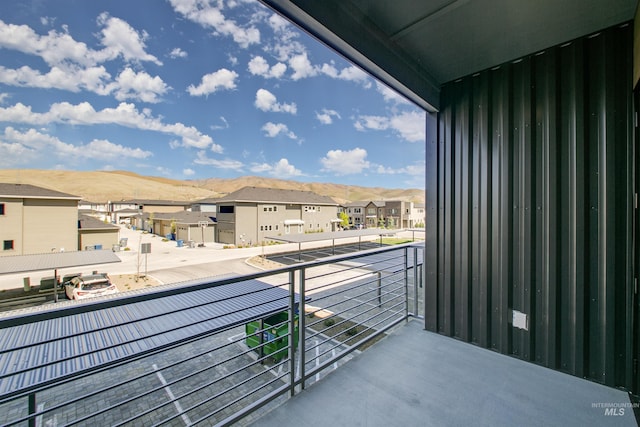 balcony with a residential view and a mountain view