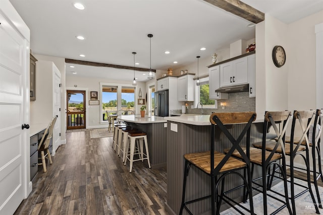 894 Main St, Star, ID 83669 - kitchen with under cabinet range hood, refrigerator with ice dispenser, recessed lighting, dark wood-style flooring, and light countertops