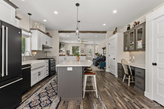894 Main St, Star, ID 83669 - kitchen featuring black appliances, dark wood finished floors, a kitchen breakfast bar, open floor plan, and recessed lighting