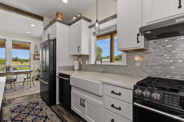 894 Main St, Star, ID 83669 - kitchen with black gas stove, freestanding refrigerator, ventilation hood, dishwashing machine, and tasteful backsplash
