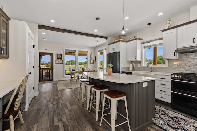 894 Main St, Star, ID 83669 - kitchen with stove, freestanding refrigerator, a kitchen bar, decorative backsplash, and recessed lighting