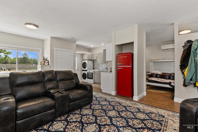 894 Main St, Star, ID 83669 - living area featuring stacked washing machine and dryer, a wall mounted air conditioner, light wood-type flooring, and recessed lighting