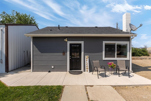 894 Main St, Star, ID 83669 - rear view of house with a patio area, a chimney, and roof with shingles