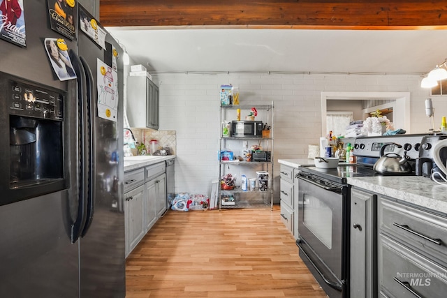909 Victoria Ave, Fruitland, ID 83619 - kitchen with stainless steel appliances, light wood-style flooring, gray cabinets, and a sink