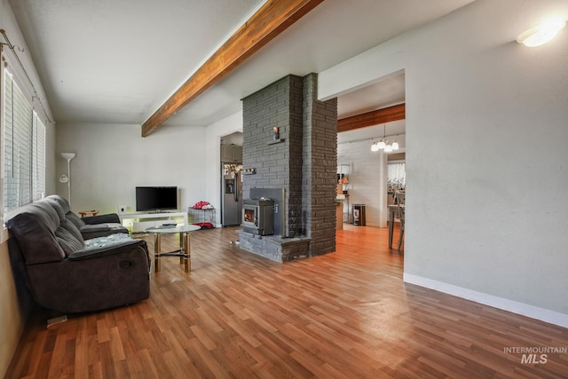 909 Victoria Ave, Fruitland, ID 83619 - living room with a chandelier, wood finished floors, beamed ceiling, and baseboards