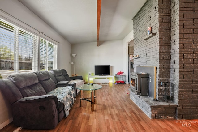 909 Victoria Ave, Fruitland, ID 83619 - living area with wood finished floors, beam ceiling, and a fireplace