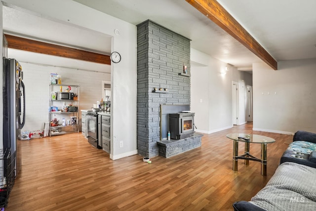 909 Victoria Ave, Fruitland, ID 83619 - living area featuring beam ceiling, wood finished floors, and baseboards