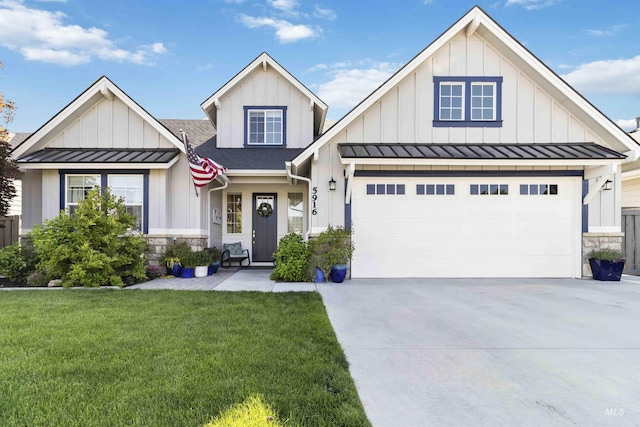 5916 S Wayland Way, Meridian, ID 83642 - view of front of home featuring a standing seam roof, board and batten siding, driveway, a front lawn, and stone siding