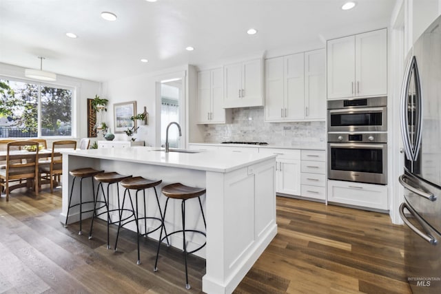 5916 S Wayland Way, Meridian, ID 83642 - kitchen with a sink, stainless steel appliances, tasteful backsplash, light countertops, and white cabinets