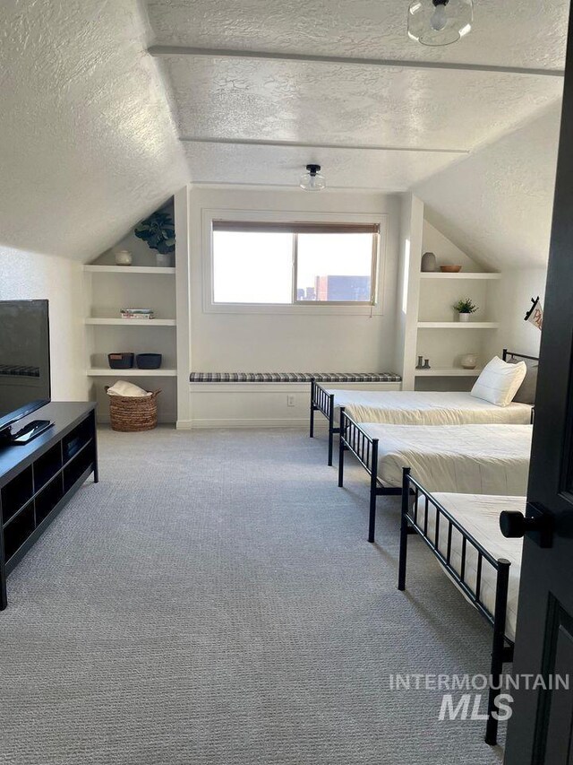 bedroom with a textured ceiling and carpet