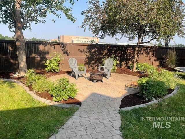 view of yard featuring a patio and a fire pit