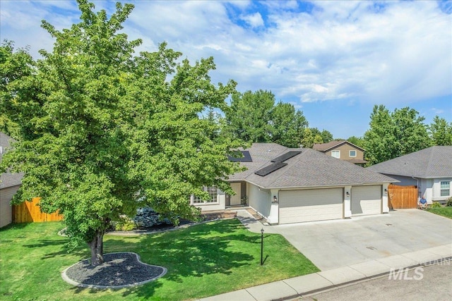4975 N Morninggale Way, Boise, ID 83713 - view of front of home with an attached garage, concrete driveway, roof mounted solar panels, and a shingled roof