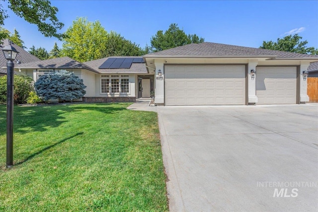 4975 N Morninggale Way, Boise, ID 83713 - single story home featuring an attached garage, concrete driveway, a front lawn, roof mounted solar panels, and stucco siding