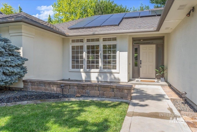 4975 N Morninggale Way, Boise, ID 83713 - view of exterior entry with solar panels, stucco siding, and a shingled roof
