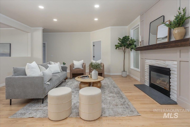 4975 N Morninggale Way, Boise, ID 83713 - living area with light wood-style flooring, recessed lighting, a fireplace, and ornamental molding