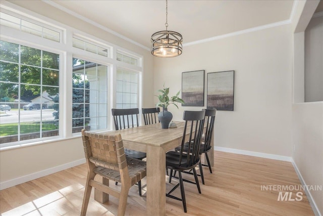 4975 N Morninggale Way, Boise, ID 83713 - dining space with healthy amount of natural light, a chandelier, light wood-style flooring, and ornamental molding