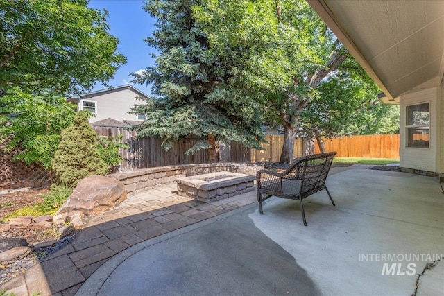 4975 N Morninggale Way, Boise, ID 83713 - fenced backyard featuring a fire pit and a patio area