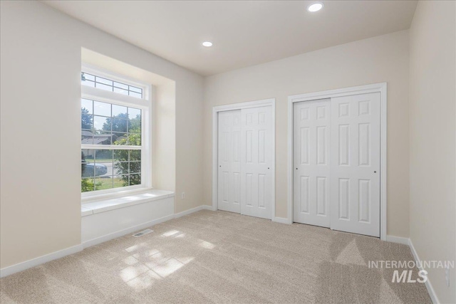 4975 N Morninggale Way, Boise, ID 83713 - unfurnished bedroom with multiple closets, carpet flooring, and recessed lighting