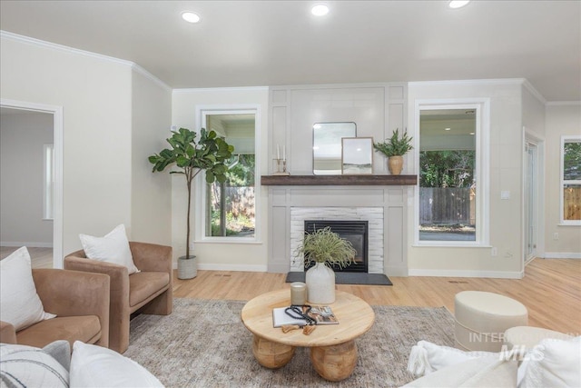 4975 N Morninggale Way, Boise, ID 83713 - living room with light wood-style floors, crown molding, a premium fireplace, and recessed lighting