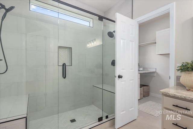 4975 N Morninggale Way, Boise, ID 83713 - full bath featuring a stall shower, vanity, tile patterned floors, and a closet