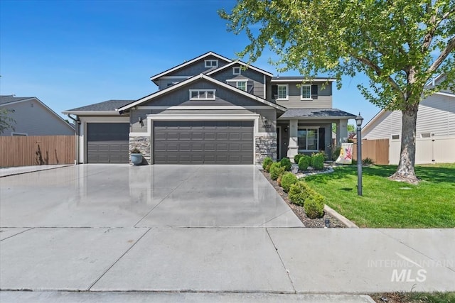 view of front facade with driveway, an attached garage, and stone siding